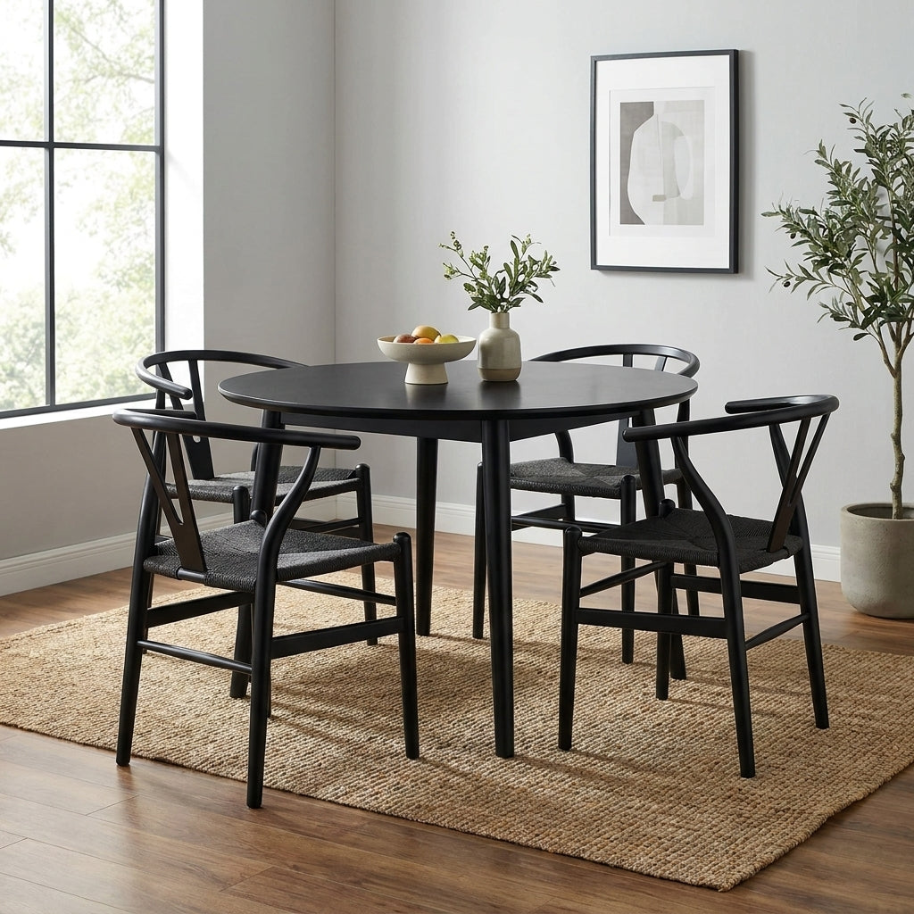 Modern dining room with black table and chairs, minimalist decor.