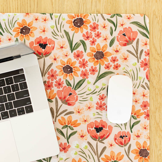 Laptop and mouse on floral print mat.
