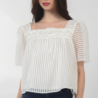 Woman wearing a white striped blouse with square neckline.