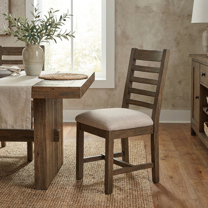 Wooden chair with a cushioned beige seat and ladder back design.
