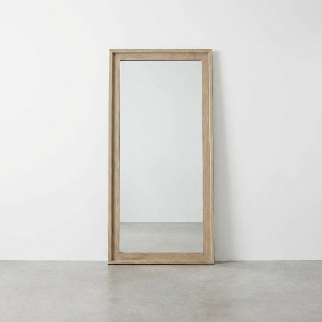 Wood-framed rectangular mirror against a white wall.