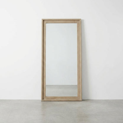 Wood-framed rectangular mirror against a white wall.