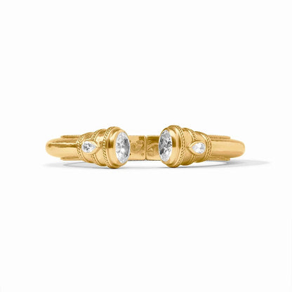 A pair of ornate gold rings with oval and round diamonds, displayed on a white background.