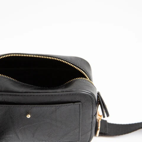 Black leather bag with open zipper and front pocket.