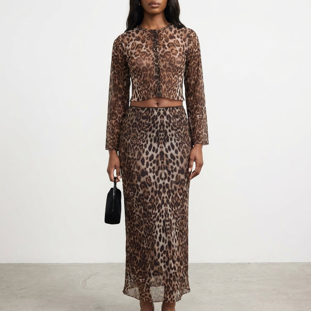 Woman in leopard-print outfit holding a small black bag.