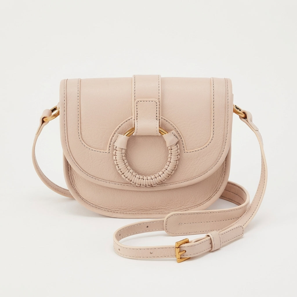 Beige crossbody bag with circular braided detail.