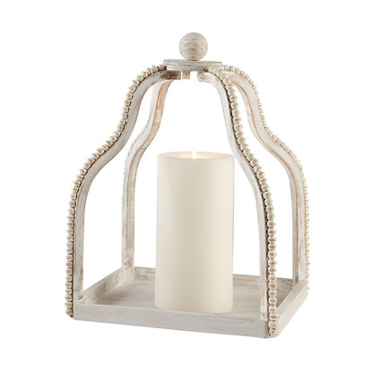 White candle in an ornate beaded lantern.
