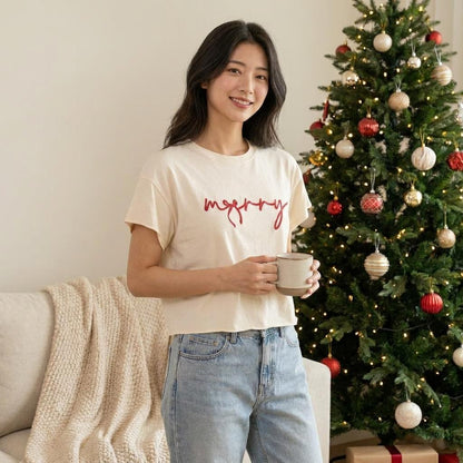 A woman holds a mug beside a decorated Christmas tree in a cozy living room.