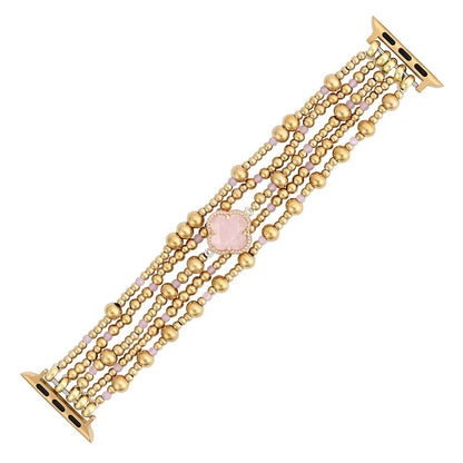 Elegant gold and pink beaded watch band with a central floral accent.