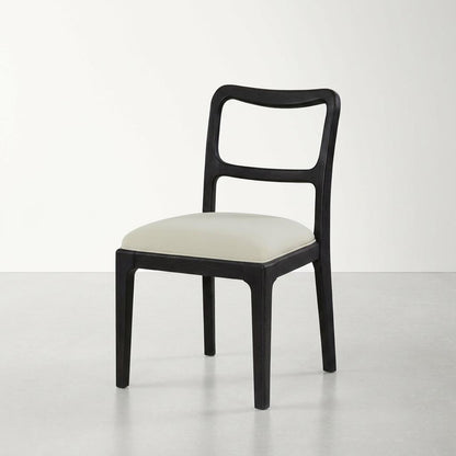 Modern black chair with a white cushioned seat on a plain background.