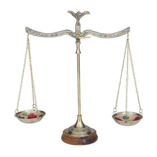 Ornate brass balance scale with decorative design.