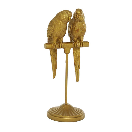 Two golden parrots perched on a decorative stand.