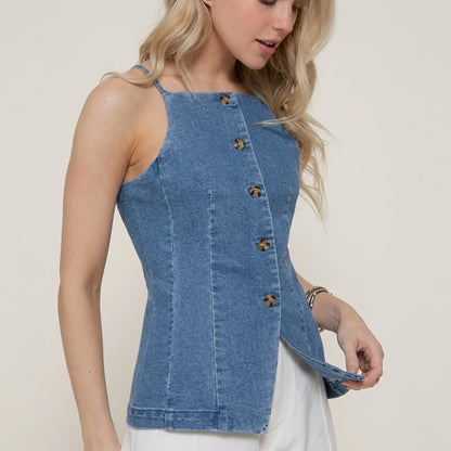 Woman in a denim top with button detailing.