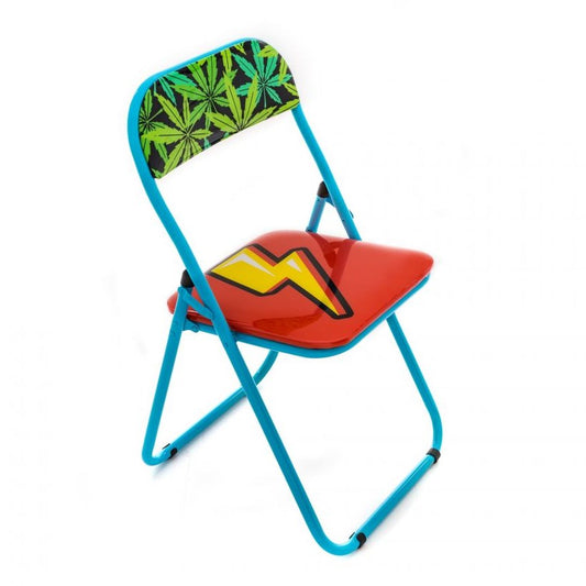 Blue folding chair, red seat with lightning bolt, green leaf backrest.