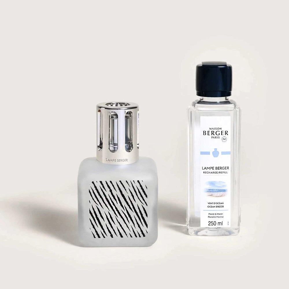 Decorative fragrance lamp and refill bottle on a light background.