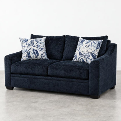 Dark blue sofa with patterned cushions on a light floor.