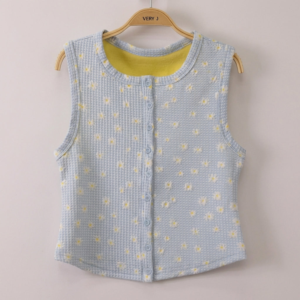 Light blue textured vest with yellow floral pattern on a hanger.