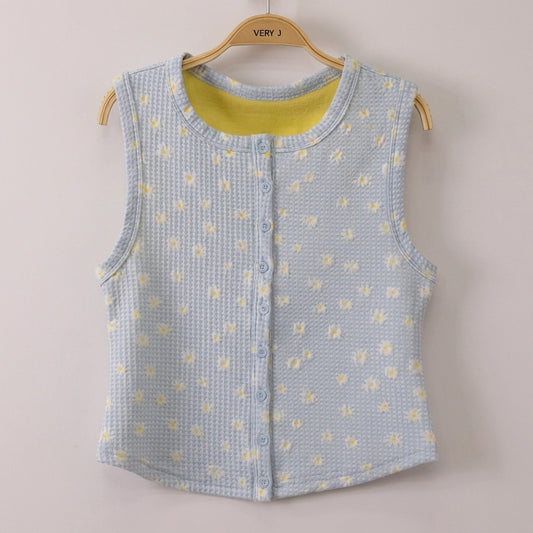 Light blue textured vest with yellow floral pattern on a hanger.