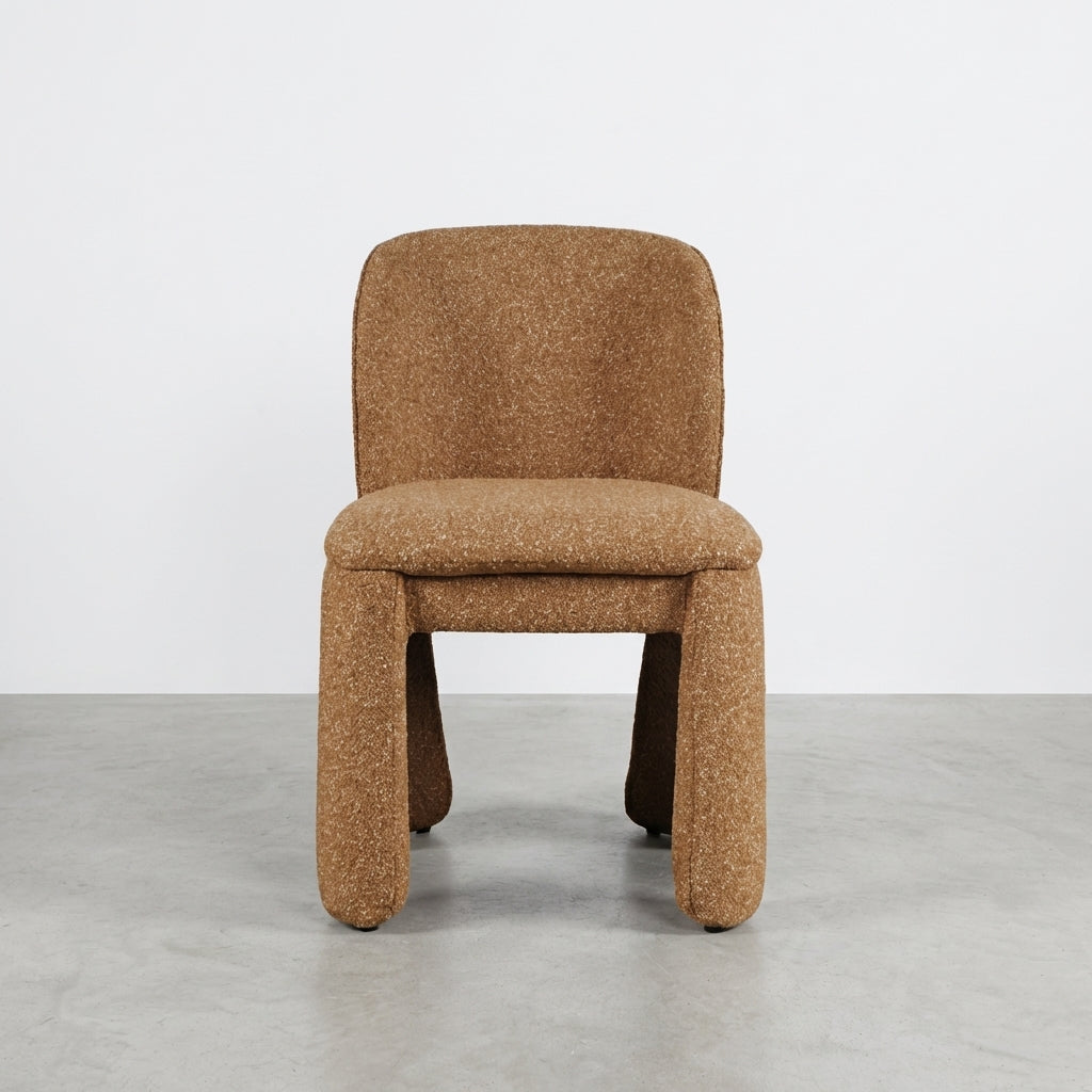 Modern brown upholstered chair with thick legs.