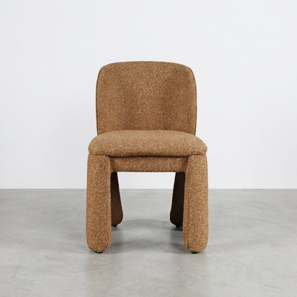 Modern brown upholstered chair with thick legs.