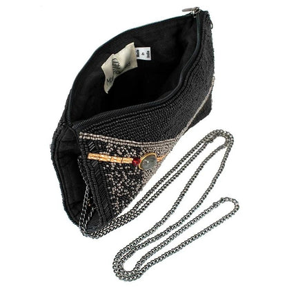 Black beaded clutch with chain strap and decorative brooch.