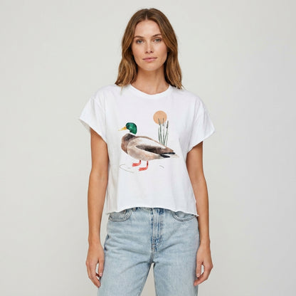 Person wearing a duck-themed white T-shirt and jeans.