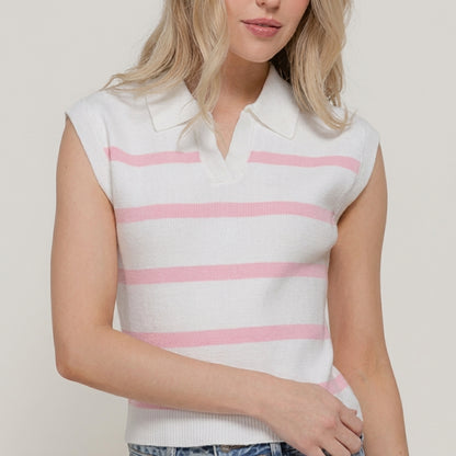 Woman in a pink-striped sleeveless shirt and jeans.