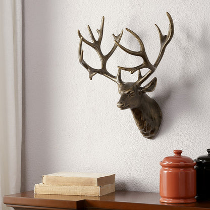Deer head sculpture on wall above shelf with books and jars.
