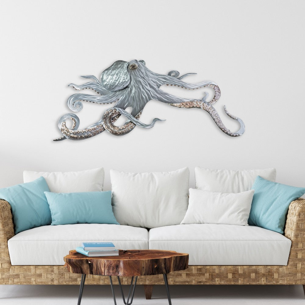 Octopus wall art above a sofa with blue cushions and a wooden coffee table.