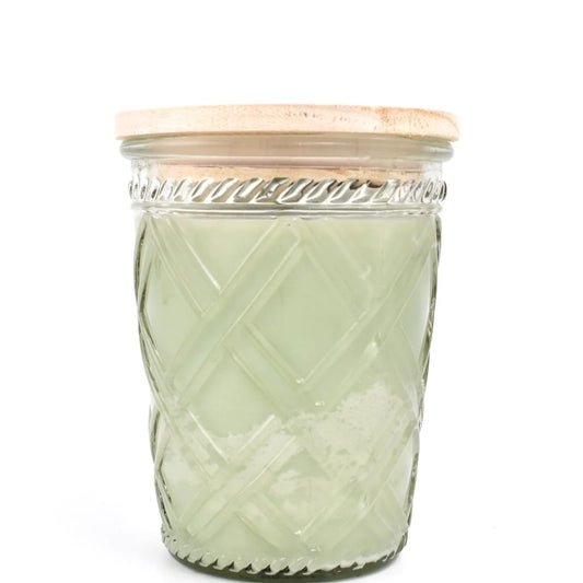 Patterned glass jar with a wooden lid.