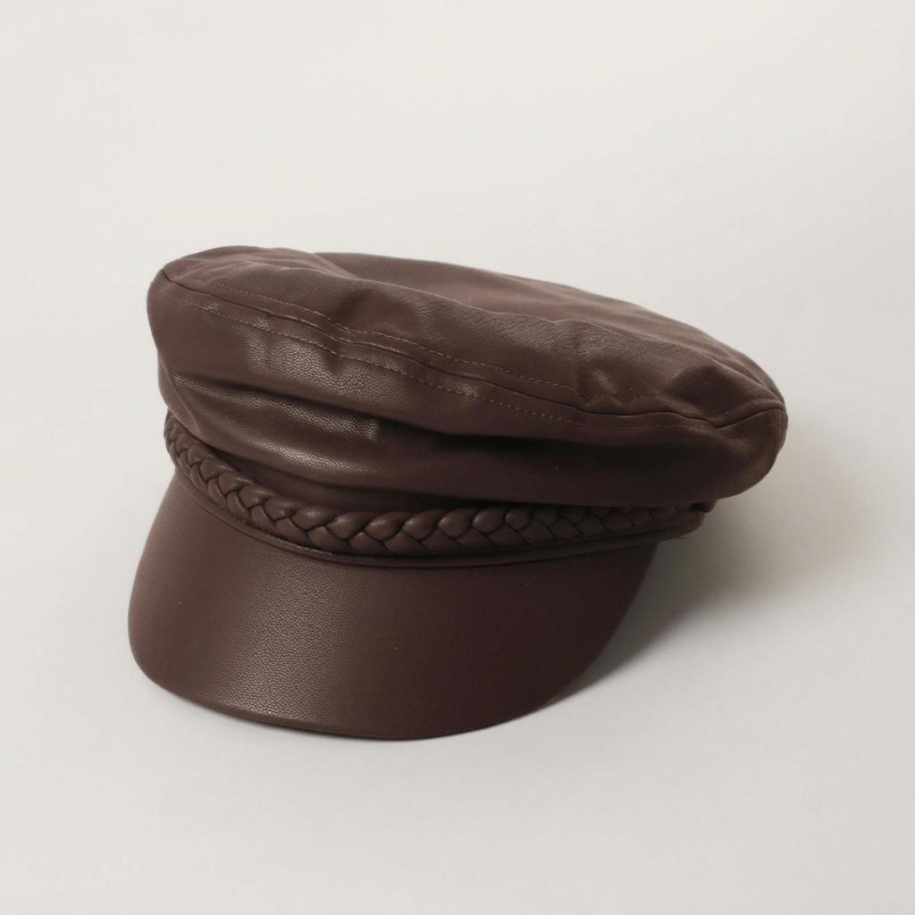 Brown faux leather cap with braided detail.