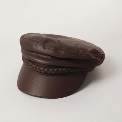 Brown faux leather cap with braided detail.