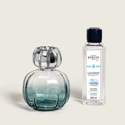 Elegant perfume bottle and refill on a light background.