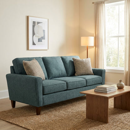 Cozy living room with blue sofa, wooden table, and floor lamp.