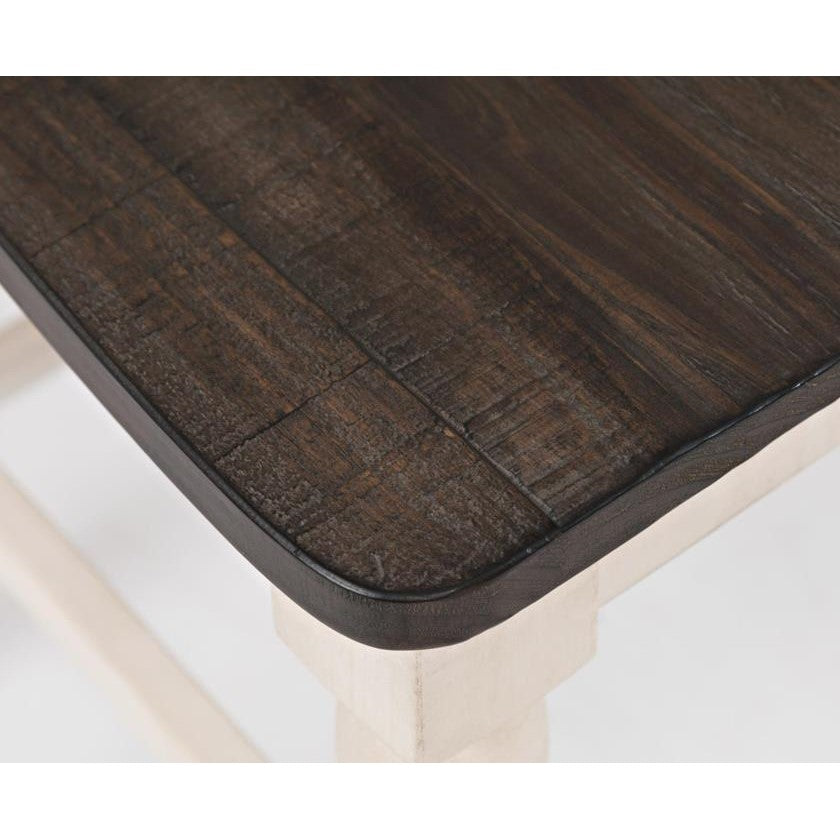 Dark wooden table corner on white legs.