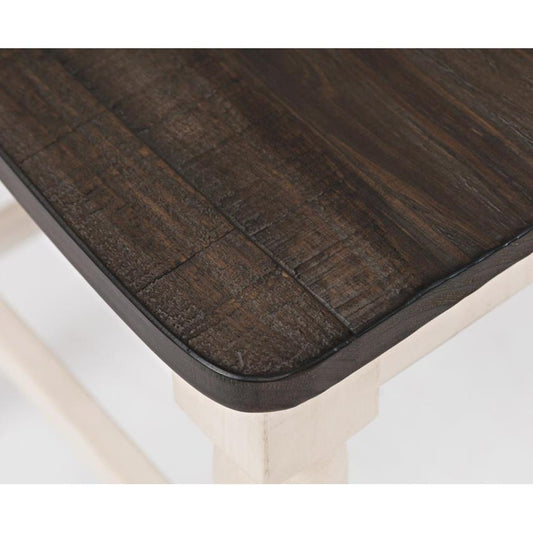 Dark wooden table corner on white legs.