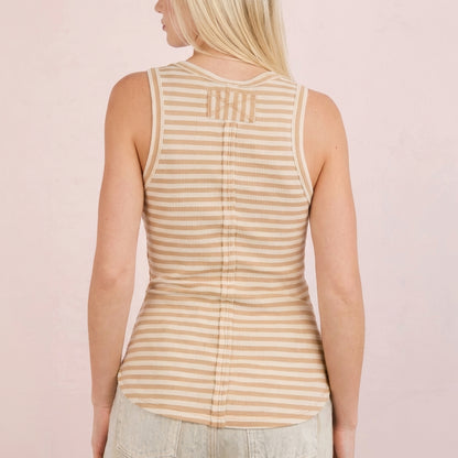 Blonde woman in a striped sleeveless top, shown from the back.