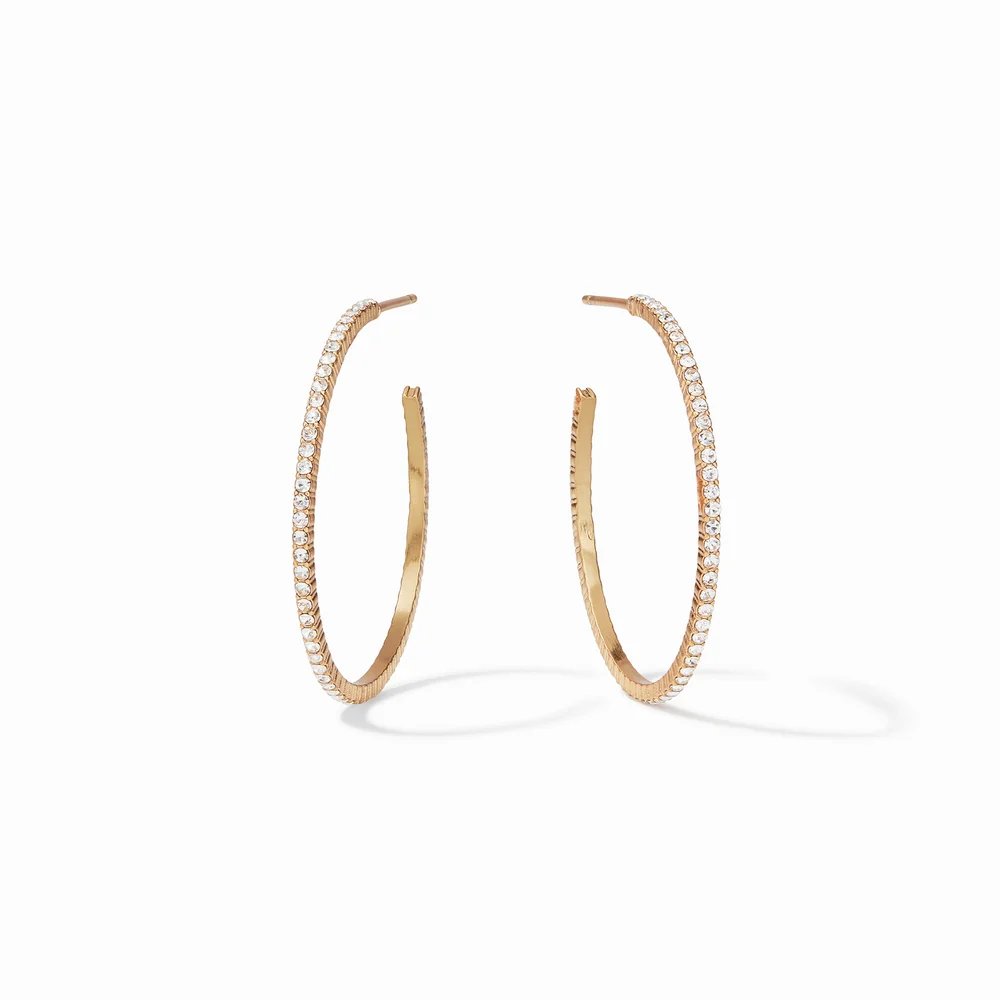 A pair of gold hoop earrings adorned with sparkling stones.