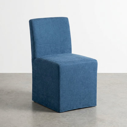 Minimalist blue upholstered chair against white background.