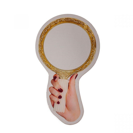 Hand holding a vintage-style round mirror with ornate gold detailing.