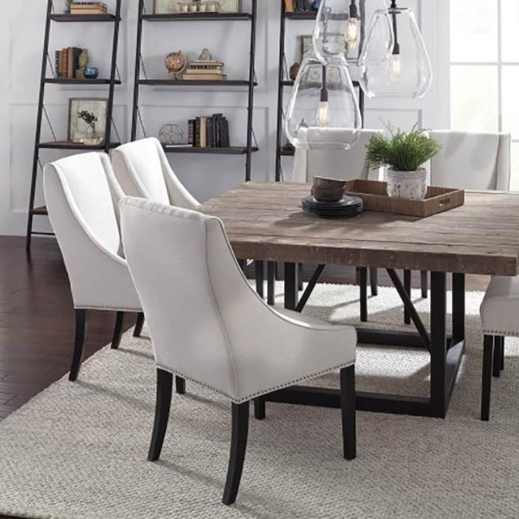 Modern dining room with white chairs and wooden table.