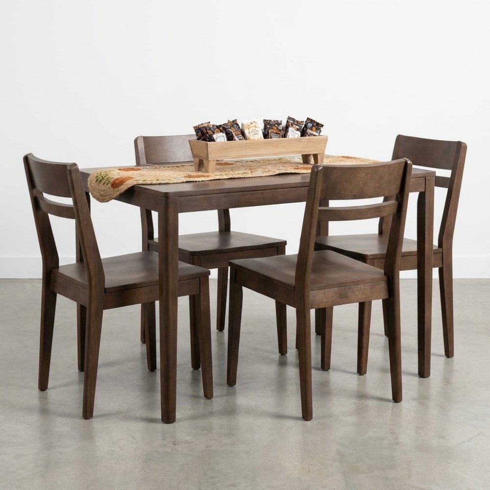 Wooden dining set with four chairs and snacks in a tray centerpiece.