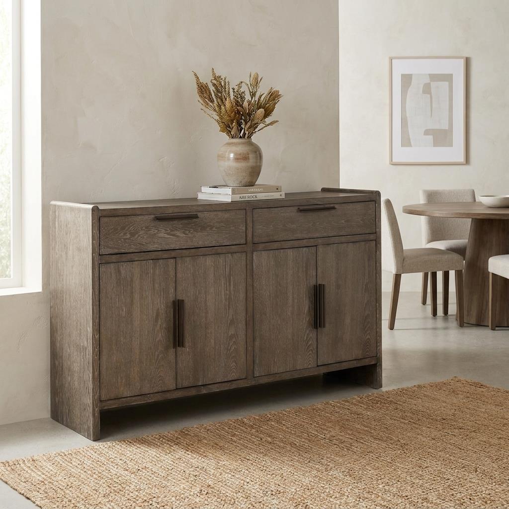 Wooden sideboard with vase, near dining table and textured rug.