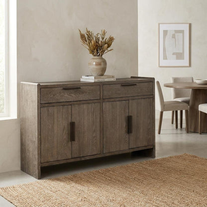 Wooden sideboard with vase, near dining table and textured rug.