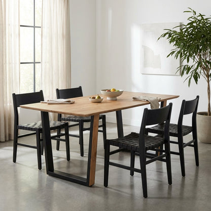 A wooden table with black metal legs in a V shape.