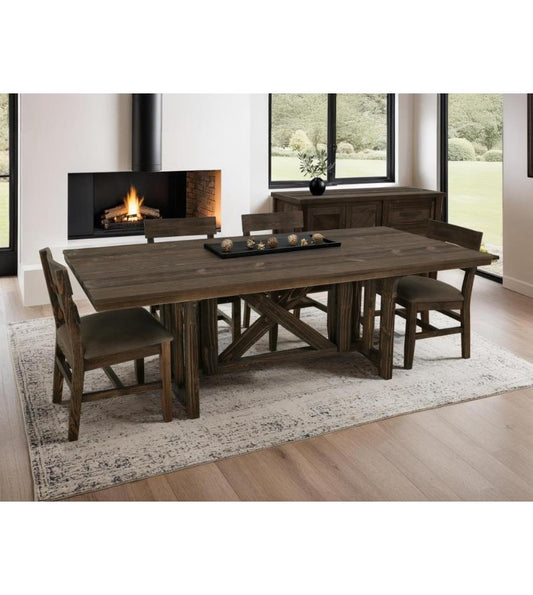 Modern dining room with wooden table, fireplace, and large windows.