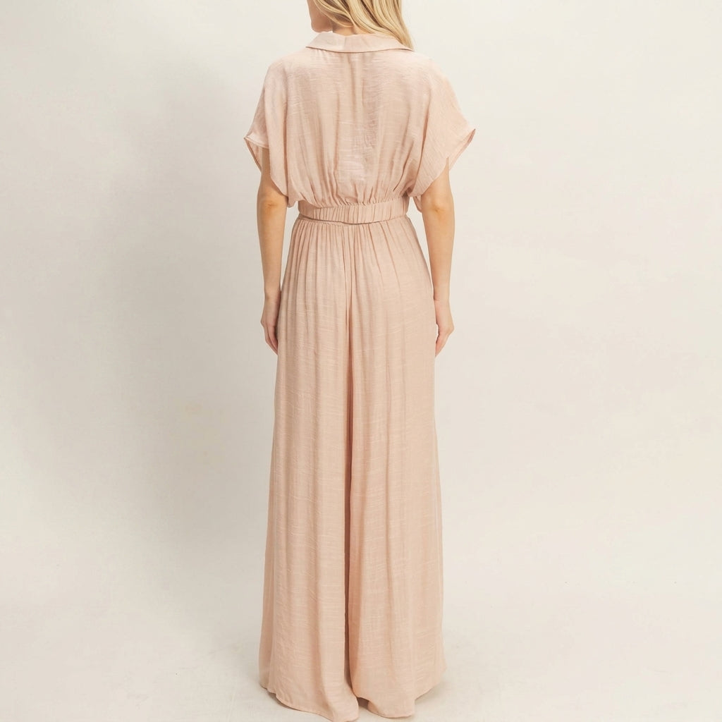 Person in a peach maxi dress, viewed from behind.