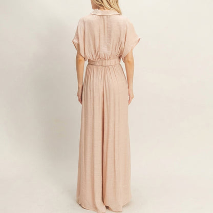 Person in a peach maxi dress, viewed from behind.