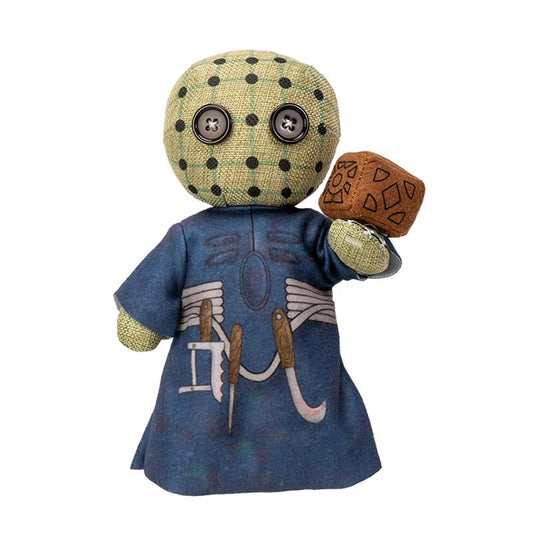 Button-eyed plush doll with patterned head, wearing a tool-printed blue outfit.