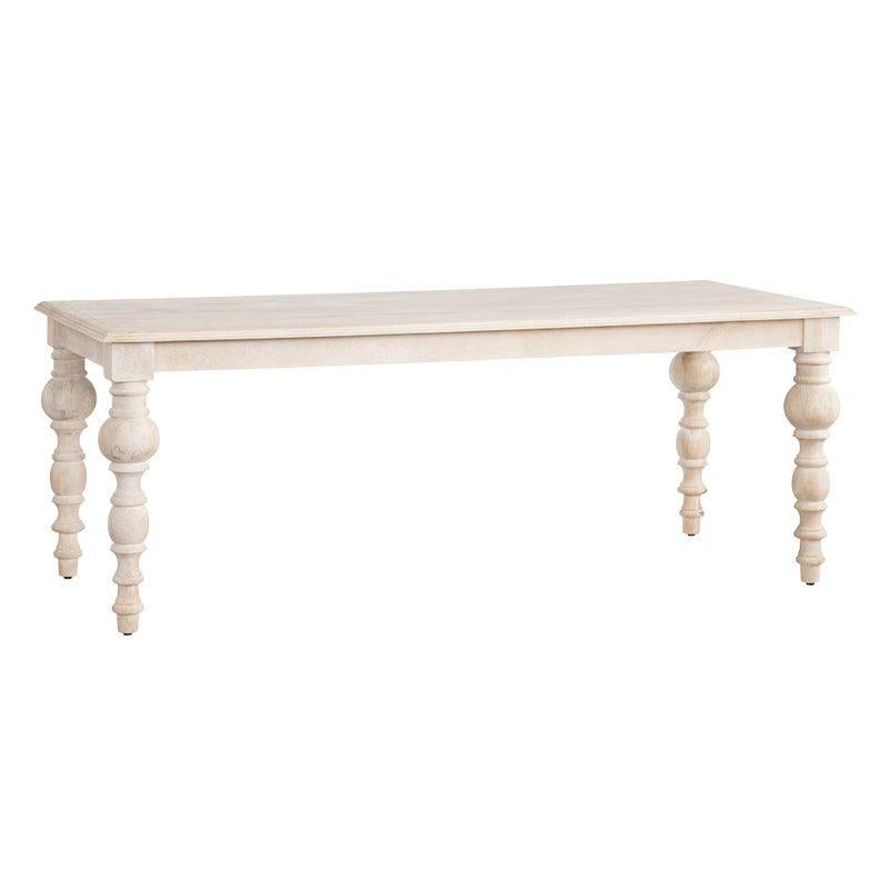 White wooden table with carved legs.